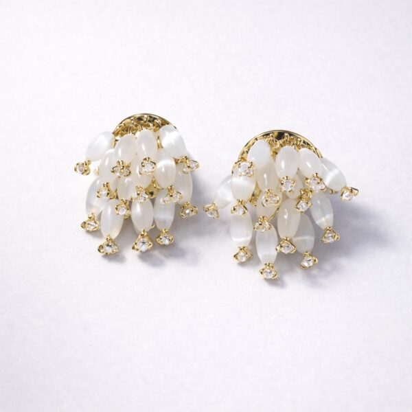 Cascading white bead gold earrings close-up